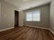 Bedroom with new floors, a window with natural light, neutral colored walls, and closet at 3650 Burnt Hickory Dr, Dacula, GA 30019