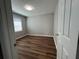 Bedroom featuring new floors, a window with natural light and neutral colored walls at 3650 Burnt Hickory Dr, Dacula, GA 30019