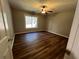 Bedroom with hardwood floors, a ceiling fan, and a large window at 3650 Burnt Hickory Dr, Dacula, GA 30019