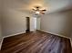 Bright bedroom with hardwood floors, ceiling fan, and closet access at 3650 Burnt Hickory Dr, Dacula, GA 30019