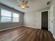 Bedroom with new floors, a ceiling fan, a window with natural light, neutral colored walls, and closet at 3650 Burnt Hickory Dr, Dacula, GA 30019