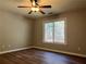 Bedroom with a large window that provides lots of natural light and a ceiling fan at 3650 Burnt Hickory Dr, Dacula, GA 30019