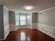 Dining room area featuring dark wood floors, neutral paint, and a bay window at 3650 Burnt Hickory Dr, Dacula, GA 30019