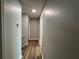 Hallway with wood floors and neutral paint, creating a seamless transition between rooms at 3650 Burnt Hickory Dr, Dacula, GA 30019