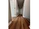 Hallway with wood floors and neutral paint, creating a seamless transition between rooms at 3650 Burnt Hickory Dr, Dacula, GA 30019