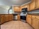 Traditional kitchen featuring natural wood cabinets and stainless steel appliances at 3650 Burnt Hickory Dr, Dacula, GA 30019