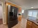 Kitchen area showcasing natural wood cabinets, granite countertops, and stainless steel refrigerator at 3650 Burnt Hickory Dr, Dacula, GA 30019