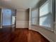 Bright living room featuring hardwood floors, large windows, and elegant wainscoting at 3650 Burnt Hickory Dr, Dacula, GA 30019