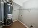 Utility room featuring a water heater, tile floors and storage shelves at 3650 Burnt Hickory Dr, Dacula, GA 30019