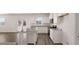 Modern white kitchen with stainless steel appliances and a granite island at 644 Kimberwick Dr, Locust Grove, GA 30248