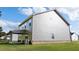 Back view of a two-story home with a covered patio and large windows at 656 Kimberwick Dr, Locust Grove, GA 30248