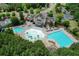 Aerial view of community clubhouse with pool, waterslide, pool area, parking, and lush surrounding trees at 226 Patti Pl, Canton, GA 30114