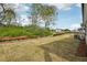 Level backyard with grassy lawn and partial view of the neighborhood at 3954 Brushy St, Powder Springs, GA 30127