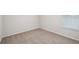 An empty bedroom featuring neutral carpet, white walls, and a window at 3954 Brushy St, Powder Springs, GA 30127