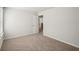 An empty bedroom featuring neutral carpet, white walls, and a window at 3954 Brushy St, Powder Springs, GA 30127
