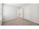 A bedroom features neutral carpet, white walls, a window and closet at 3954 Brushy St, Powder Springs, GA 30127