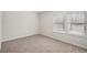 An empty bedroom features neutral carpet, white walls, and two windows at 3954 Brushy St, Powder Springs, GA 30127