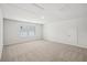Bright bonus room with neutral carpet, white walls, two windows and access door at 3954 Brushy St, Powder Springs, GA 30127