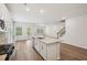 A kitchen with stainless steel appliances, granite countertops, white cabinets and an island with a sink and dishwasher at 3954 Brushy St, Powder Springs, GA 30127