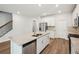 A kitchen showcases granite countertops, stainless steel appliances, white cabinets and an island with a sink and dishwasher at 3954 Brushy St, Powder Springs, GA 30127
