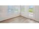 Bright room featuring laminate flooring, windows, and a door to the outside at 3954 Brushy St, Powder Springs, GA 30127