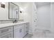 Bathroom featuring a tiled accent wall and a modern sink and vanity, marble countertop at 10745 Shallowford Rd, Roswell, GA 30075