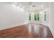 Bright, spacious bedroom with large windows, hardwood floors, and recessed lighting at 10745 Shallowford Rd, Roswell, GA 30075