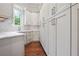 Bright kitchen area featuring lots of cabinet space, hardwood floors, and quartz countertops at 10745 Shallowford Rd, Roswell, GA 30075
