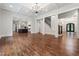 Open-concept living room with hardwood floors connecting to the kitchen and staircase at 10745 Shallowford Rd, Roswell, GA 30075