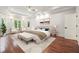 Bright bedroom with tray ceilings, hardwood floors, and cozy sitting area at 10745 Shallowford Rd, Roswell, GA 30075