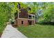 A beautiful backyard features a lush lawn and the home's inviting exterior at 1303 N Druid Hills Ne Rd, Brookhaven, GA 30319