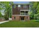 A lush backyard features a well-maintained lawn with a view of the home's exterior at 1303 N Druid Hills Ne Rd, Brookhaven, GA 30319