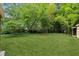 Expansive backyard with a lush lawn and mature trees providing a tranquil setting at 1303 N Druid Hills Ne Rd, Brookhaven, GA 30319