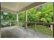 Relaxing covered balcony with tiled floor and a view of lush greenery at 1303 N Druid Hills Ne Rd, Brookhaven, GA 30319
