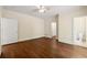 Bedroom boasts hardwood floors, ceiling fan, door to bathroom, and door to closet at 1303 N Druid Hills Ne Rd, Brookhaven, GA 30319