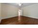 Spacious bedroom with hardwood floors, ceiling fan, and an entry door in the background at 1303 N Druid Hills Ne Rd, Brookhaven, GA 30319