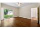 Bedroom features hardwood floors, ceiling fan, and glass sliding doors to the backyard at 1303 N Druid Hills Ne Rd, Brookhaven, GA 30319