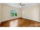 Bedroom featuring hardwood floors, ceiling fan, and natural light from a large window at 1303 N Druid Hills Ne Rd, Brookhaven, GA 30319
