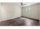 This bedroom features dark laminate floors and a ceiling fan at 1303 N Druid Hills Ne Rd, Brookhaven, GA 30319