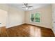 Bedroom features hardwood floors, bright window and ceiling fan at 1303 N Druid Hills Ne Rd, Brookhaven, GA 30319