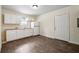 This kitchen is equipped with white cabinets, a small window and a laminate floor at 1303 N Druid Hills Ne Rd, Brookhaven, GA 30319