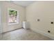 Bright laundry room featuring tile flooring, window, utility sink, and washer/dryer hookups at 1303 N Druid Hills Ne Rd, Brookhaven, GA 30319