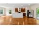 Open concept living room features a large kitchen and hardwood floors at 1303 N Druid Hills Ne Rd, Brookhaven, GA 30319
