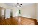 This main bedroom features wood flooring, a ceiling fan and a closet at 1303 N Druid Hills Ne Rd, Brookhaven, GA 30319