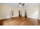 This main bedroom features wood flooring, a ceiling fan and ensuite bathroom and closet at 1303 N Druid Hills Ne Rd, Brookhaven, GA 30319