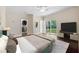 Serene main bedroom featuring neutral tones, a walk-in closet, and sliding glass doors leading to outdoor at 1303 N Druid Hills Ne Rd, Brookhaven, GA 30319