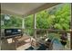 Covered patio with plush furniture overlooks a private backyard and in-ground pool at 1303 N Druid Hills Ne Rd, Brookhaven, GA 30319