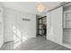 Bright bedroom features neutral walls, wood flooring, and sliding barn-style closet door at 1310 Dillon Rd, Austell, GA 30168