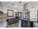 Kitchen featuring stainless appliances, dark counters and backsplash, and cooktop island with range hood at 1310 Dillon Rd, Austell, GA 30168