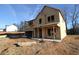 New home under construction with wood frame and covered porch, offering a blank canvas for personalization at 206 Wild Ginger Bend, Woodstock, GA 30188